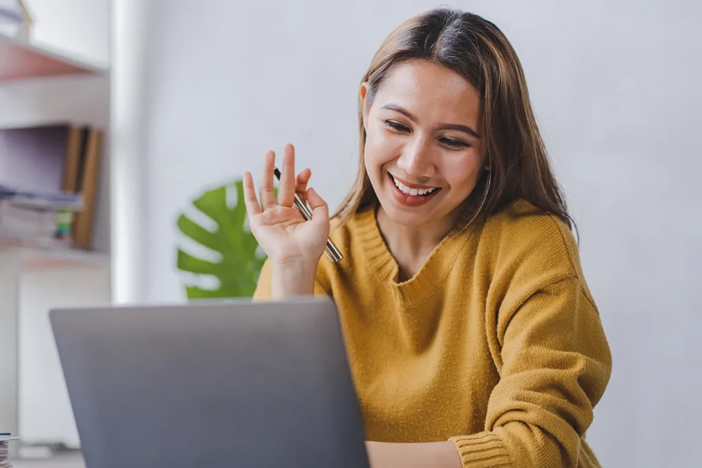 Woman smiling at online meeting