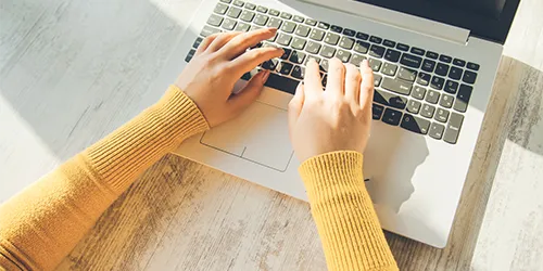 Woman typing at computer