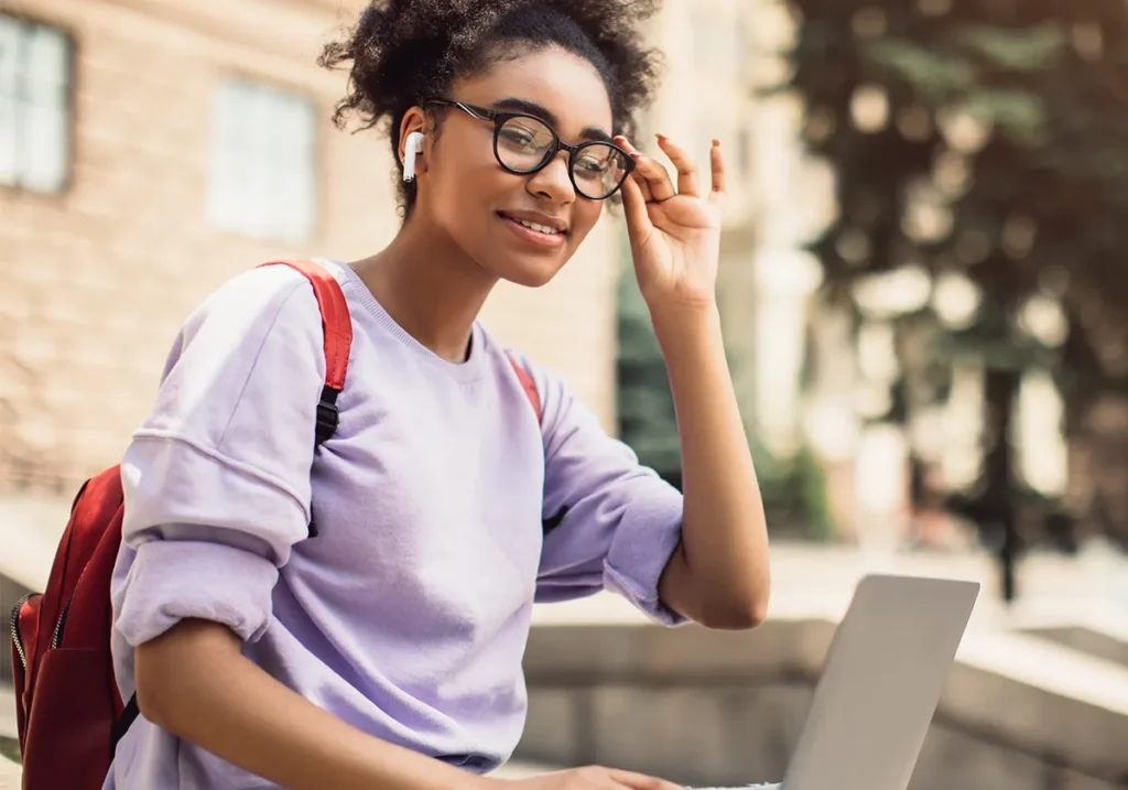 student with glasses and computer