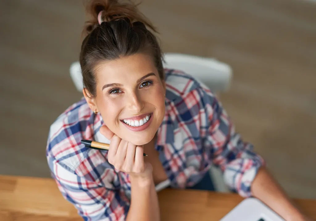 woman smiling on computer